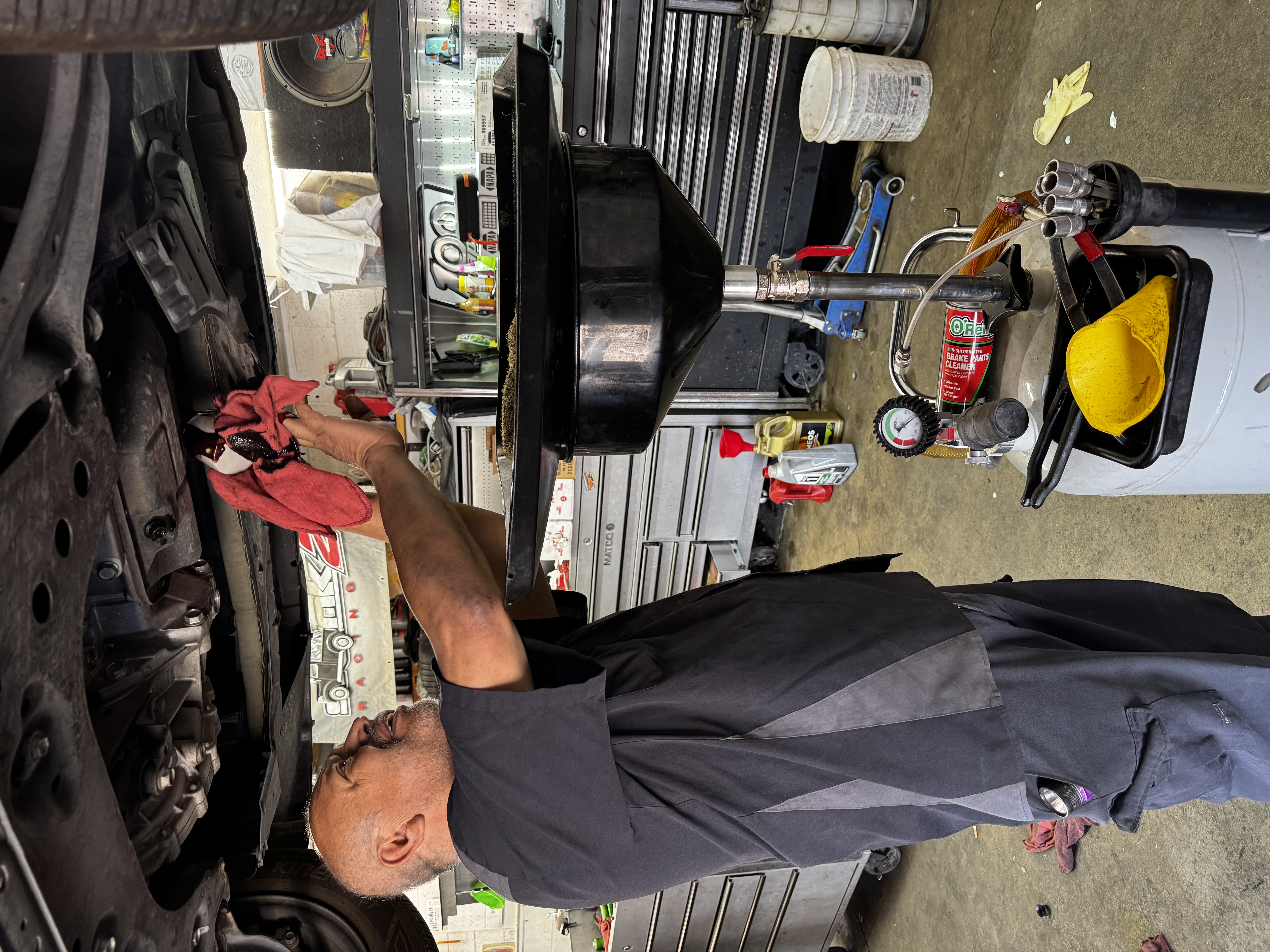 Technician working under a lifted vehicle